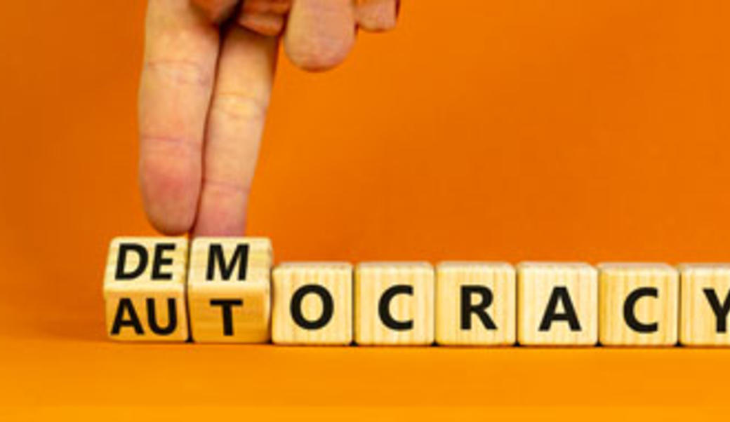 block letter spelling out autocracy and democracy