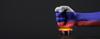 Fist on top of nuclear button with Russian flag superimposed