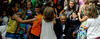 President Obama with a group of children, his arms outstretched